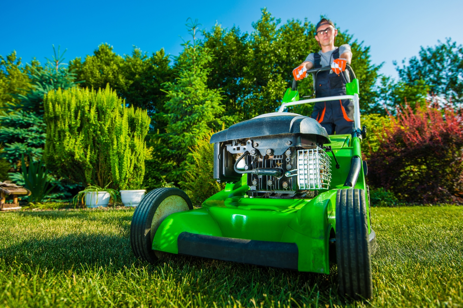 professional landscaping services clearview property maintenance Couple collects garbage in garbage bags in park